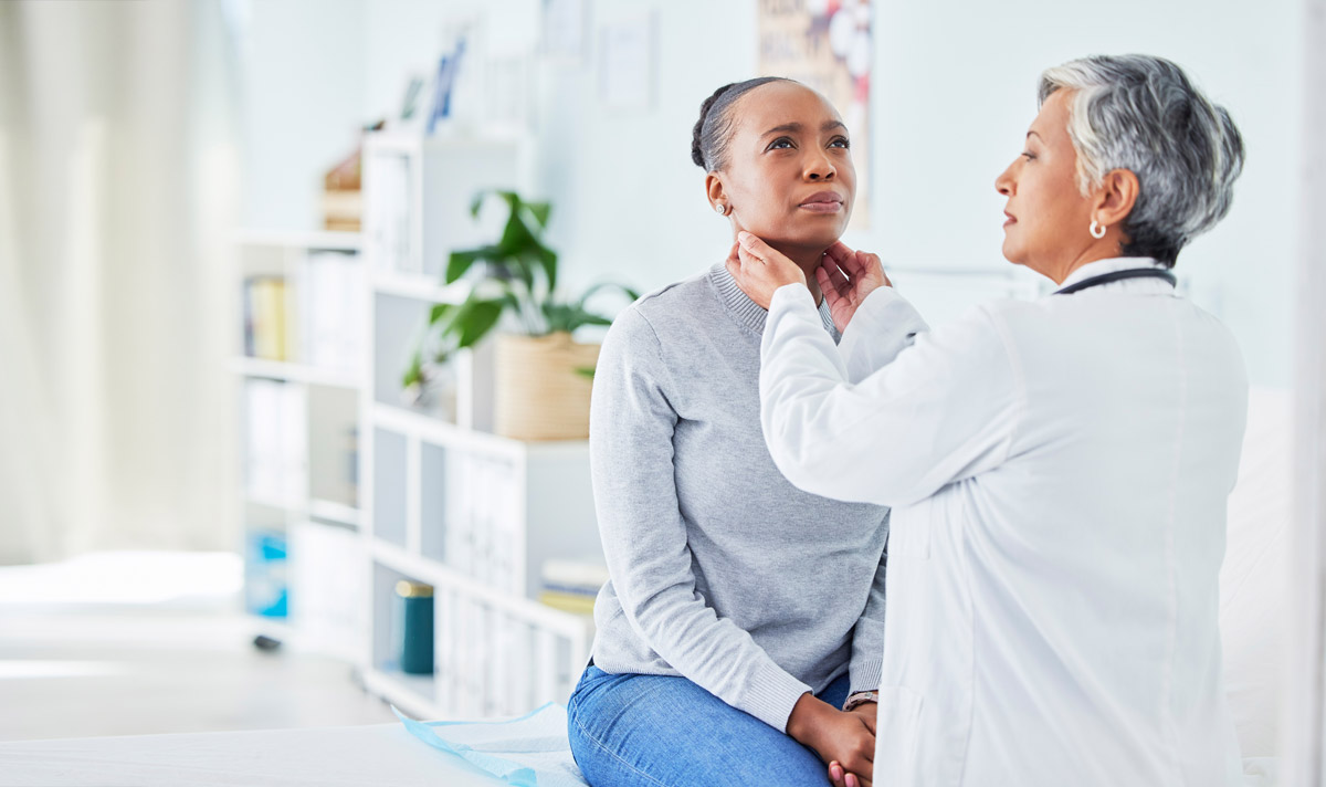 doctor feeling a patient's neck glands for inflammation